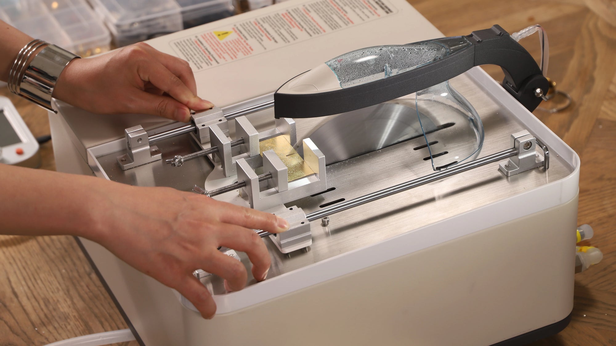 The intelligent cutting machine in the image is using a fixture to cut small, high-value materials stably and precisely.