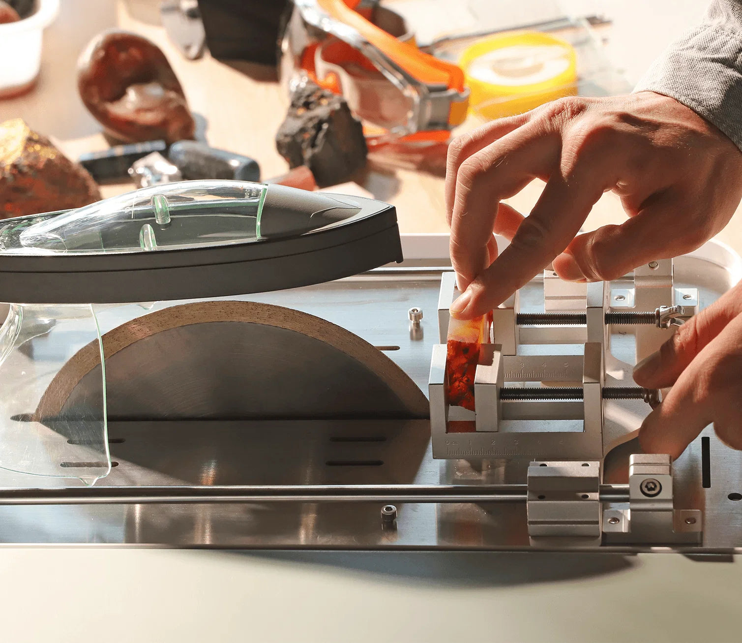 Intelligent gem cutting machine with safety fixture cutting gemstone, safe holding tool for jewelry processing.